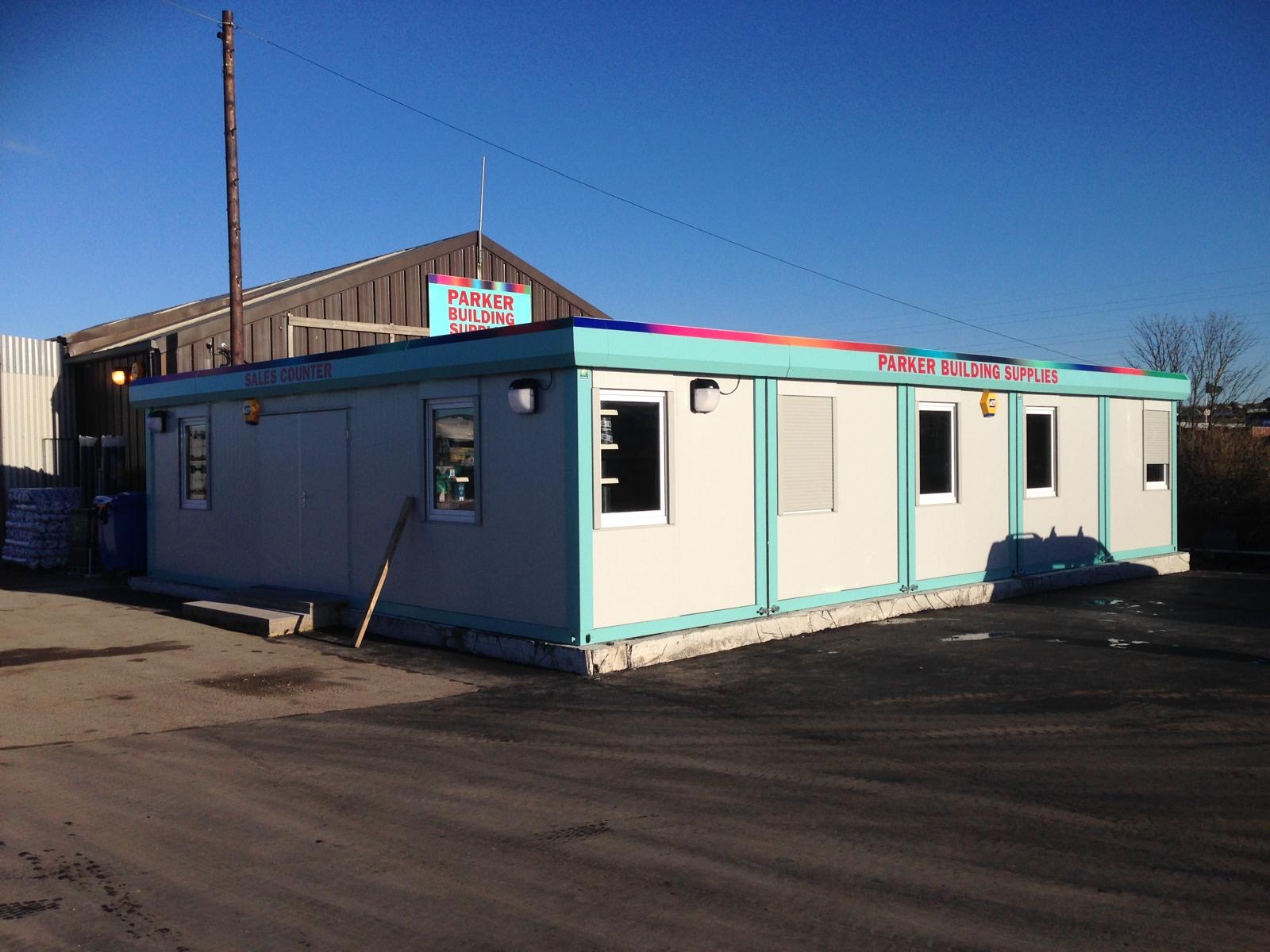 Turquoise and white modular sales counter building branded for Parker Building Supplies
