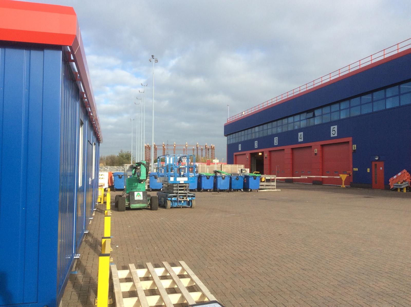 Blue modular office block with red trim installed in a busy station yard